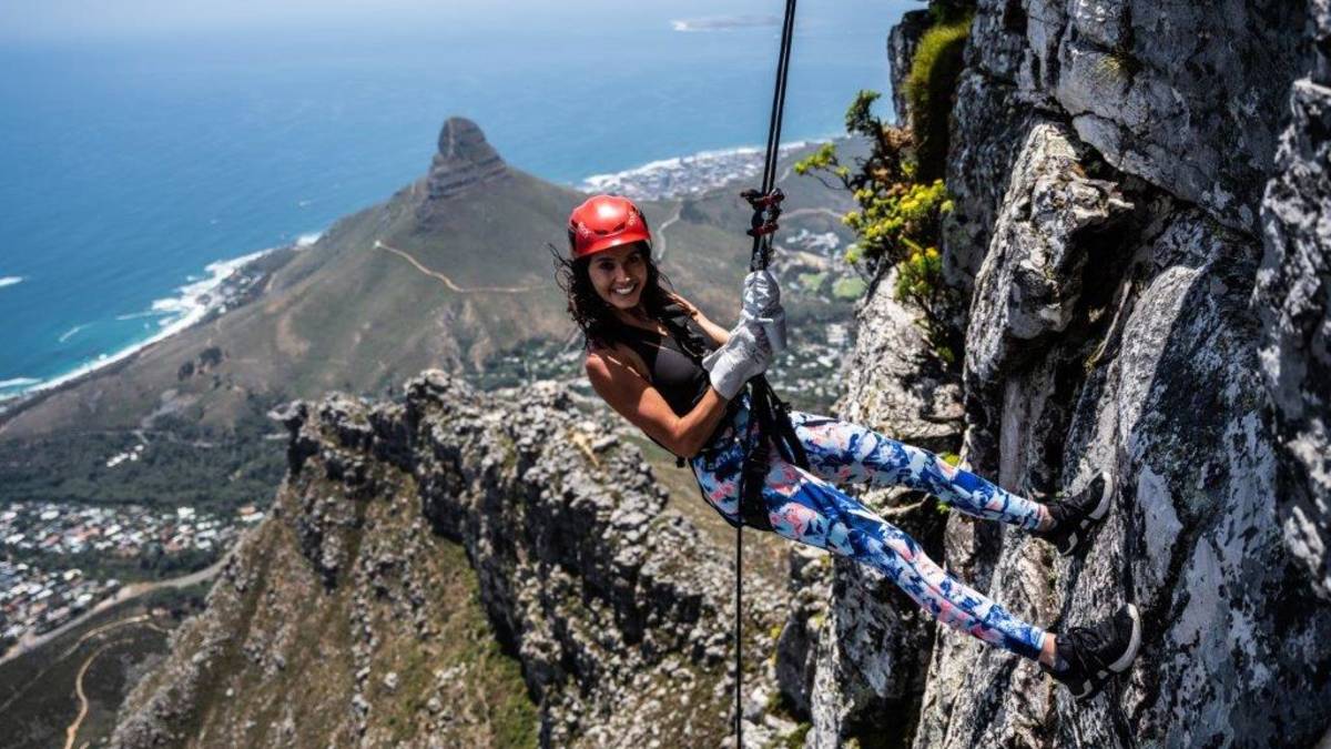 Abseiling down Table Mountain above Cape Town and the Atlantic Ocean